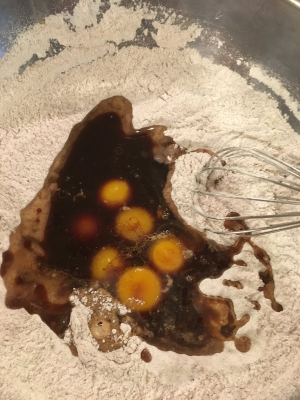 Mixing the dry ingredients with the wet.