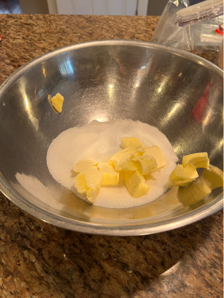 Preparing the jam crostata starts with butter and sugar. 