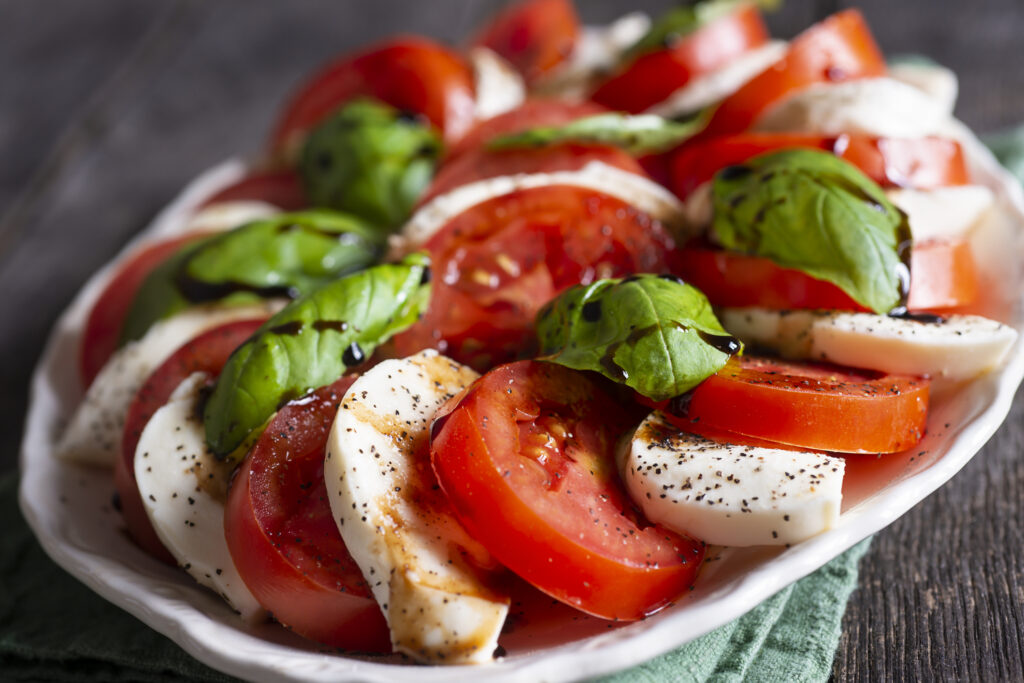 Caprese salad with a drizzle of balsamic glaze.