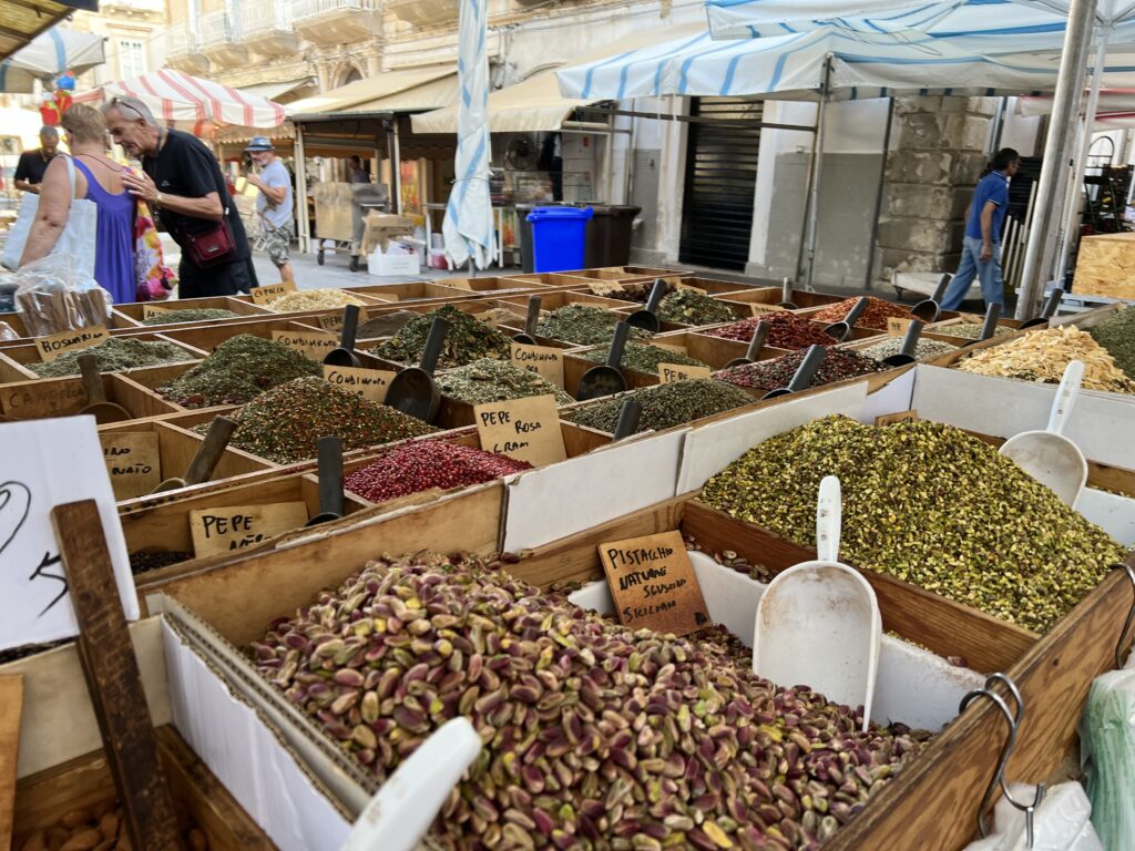 dry nuts, spices and herbs at an outdoor market.
