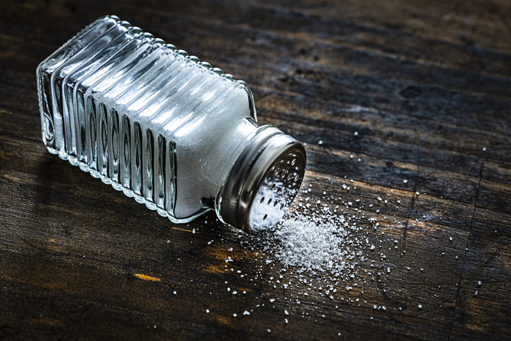 Salt on the table after it fell out of the salt shaker. 