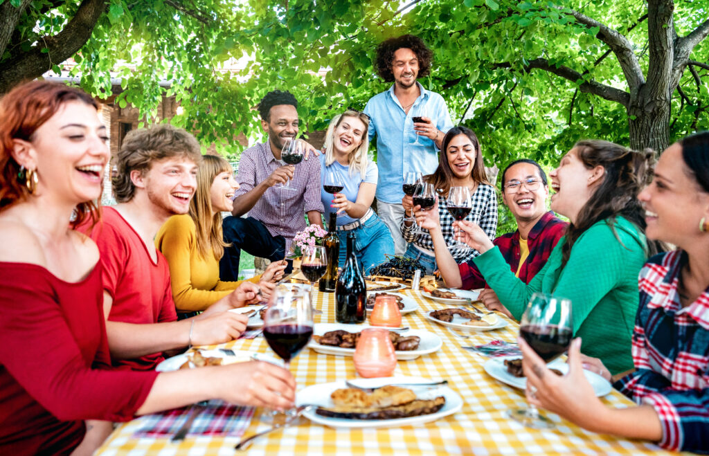 Fun group of friends enjoying an outdoor lunch. 